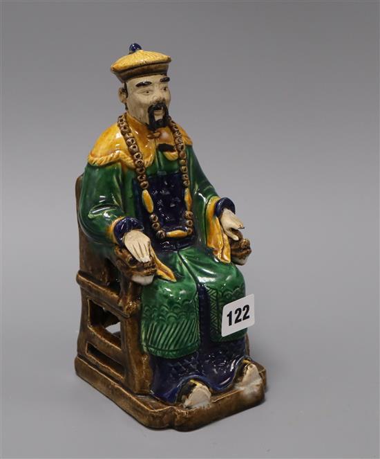 A Chinese seated figure of a mandarin 24cm high